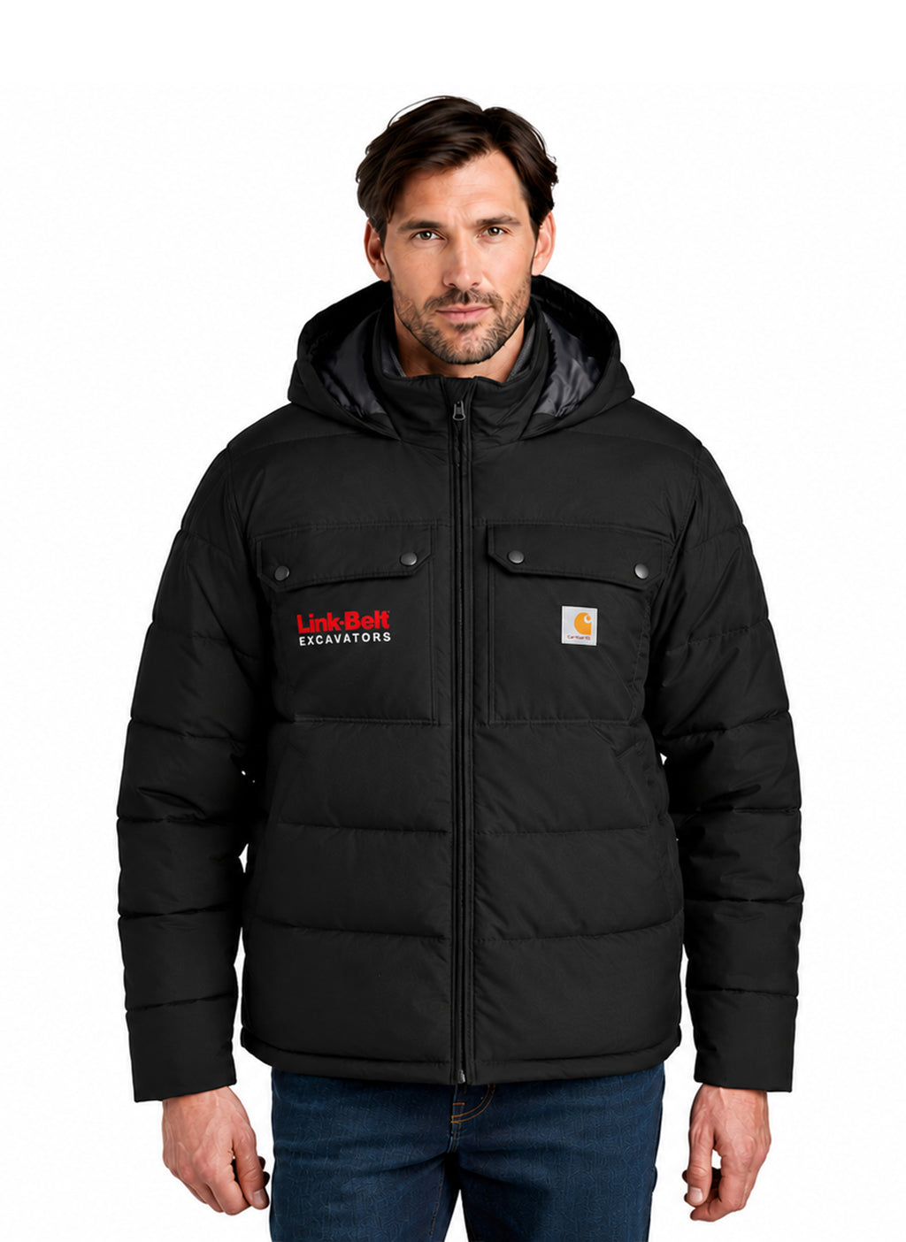 A man wearing a black hooded puffer jacket with a full zipper, snap-flap chest pockets, and visible Carhartt and Link-Belt Excavators logos, paired with blue jeans against a plain white background.